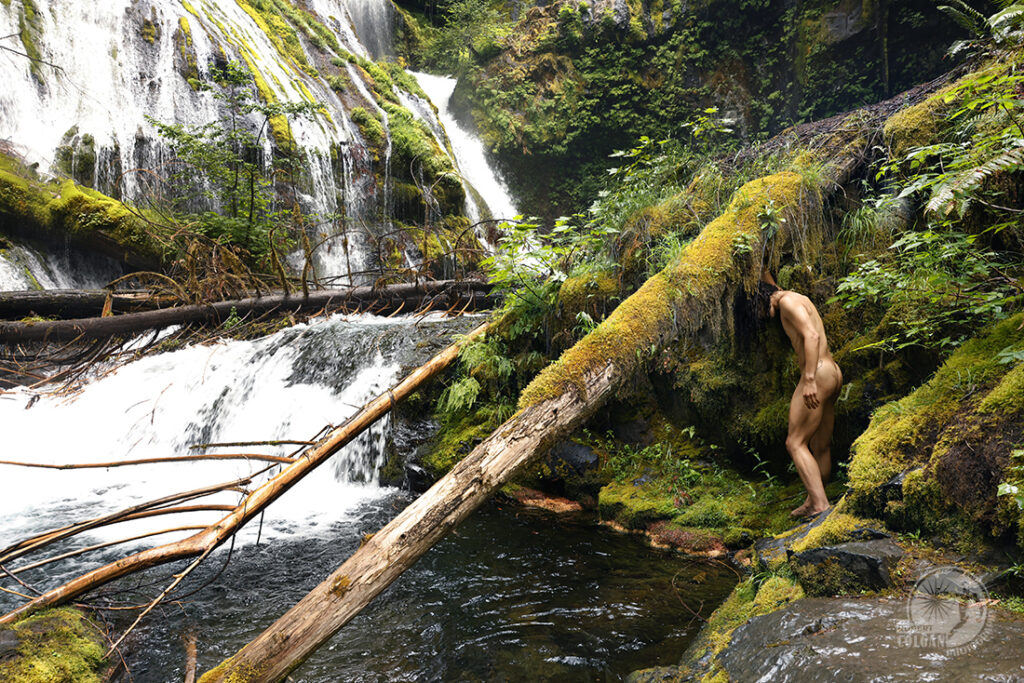 nude man attempts to explore waterfall