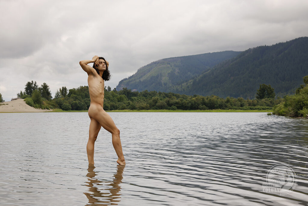 nude man twisting body in river